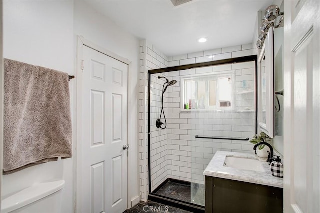 bathroom featuring vanity, toilet, and an enclosed shower