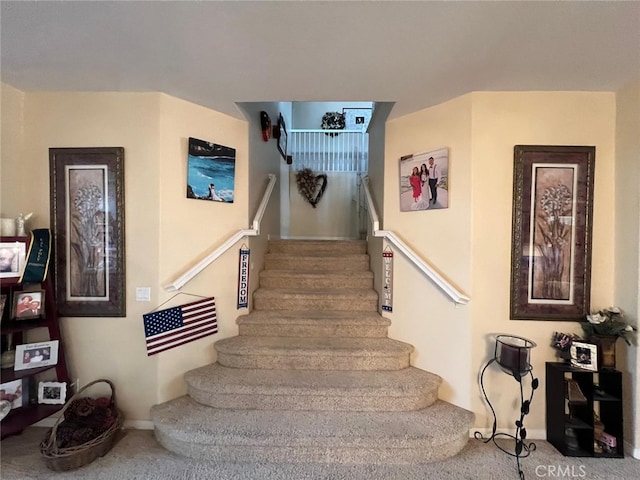 stairs featuring carpet