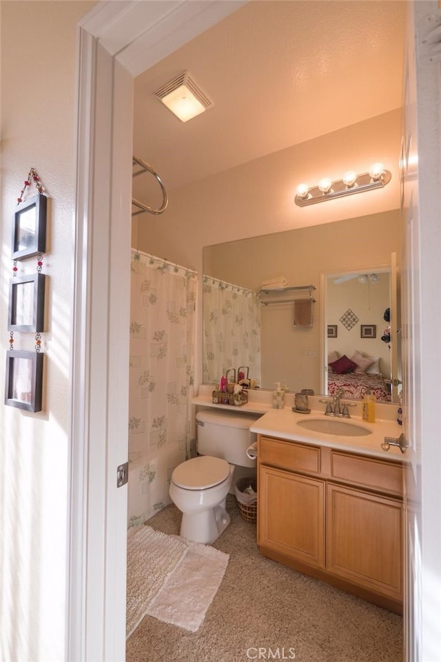 full bathroom with vanity, shower / bath combo, and toilet