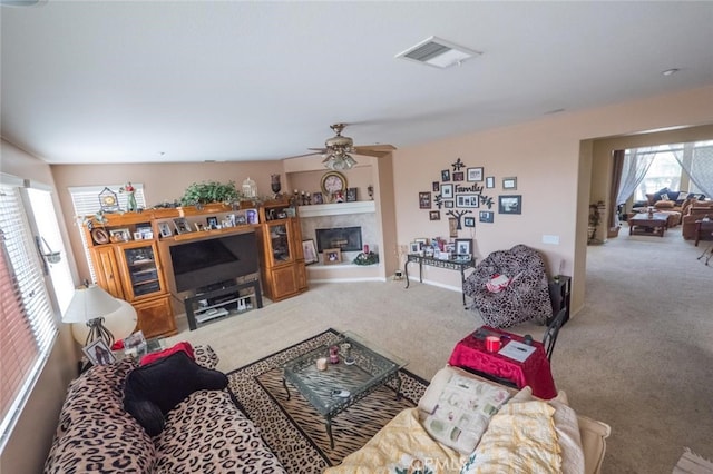 carpeted living room with ceiling fan