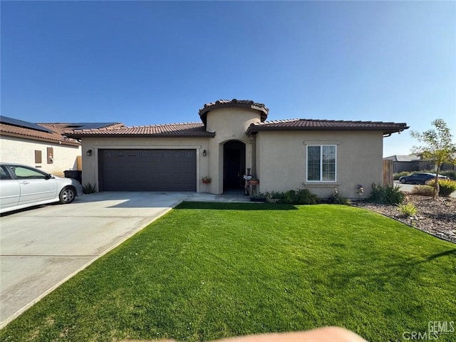 mediterranean / spanish-style home featuring a front yard and a garage