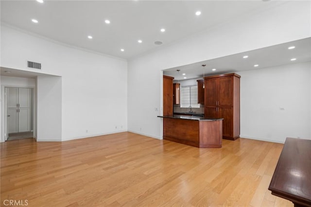 unfurnished living room with sink and light wood-type flooring