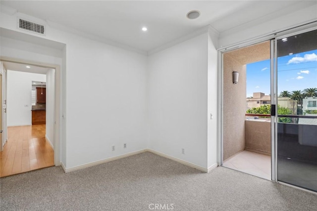 spare room featuring crown molding and wood-type flooring