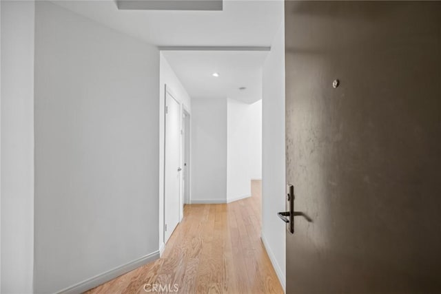 corridor with light wood-type flooring