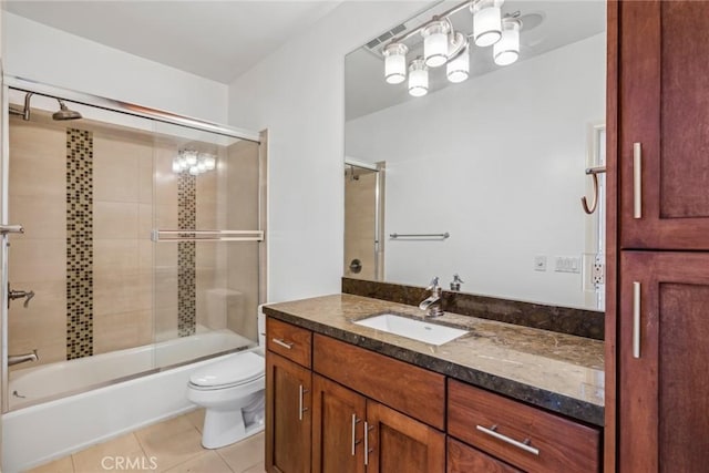 full bathroom with tile patterned flooring, vanity, toilet, and enclosed tub / shower combo