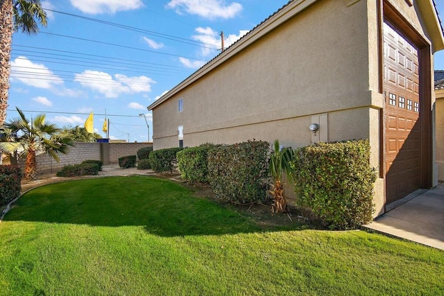 view of side of home featuring a lawn