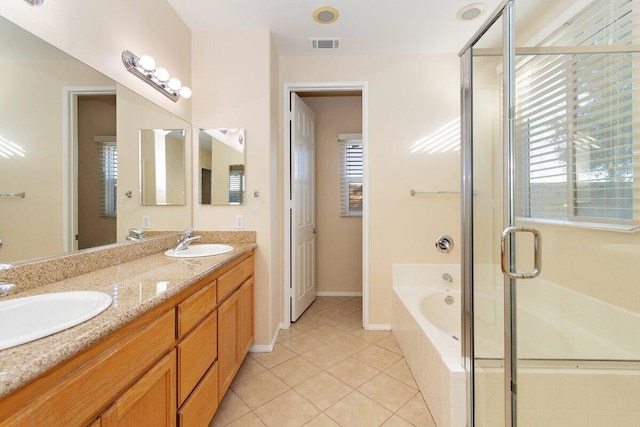 bathroom with tile patterned floors, vanity, separate shower and tub, and a healthy amount of sunlight