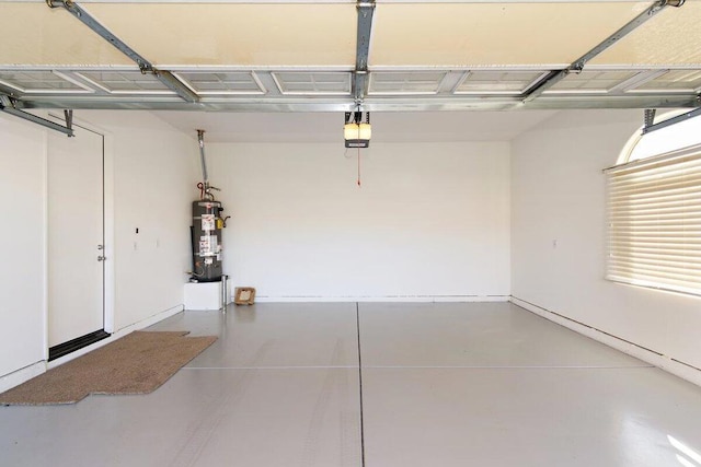 garage featuring secured water heater and a garage door opener