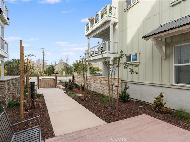 view of side of home with a balcony