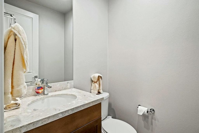 bathroom featuring toilet and vanity