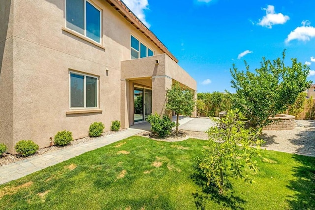 rear view of property featuring a lawn