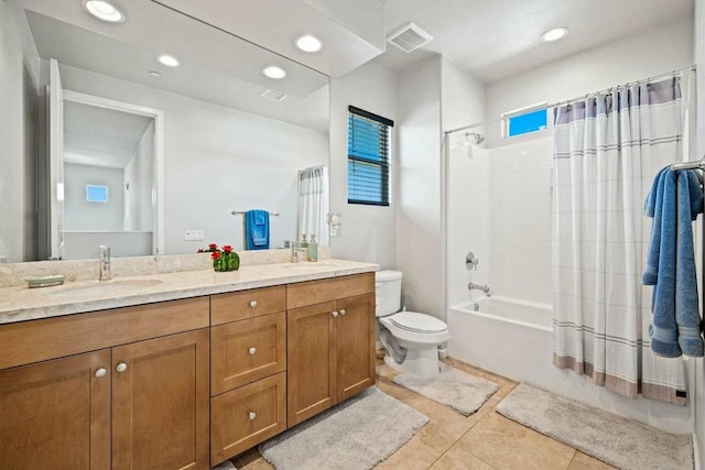 full bathroom featuring shower / bath combo, a healthy amount of sunlight, toilet, and vanity