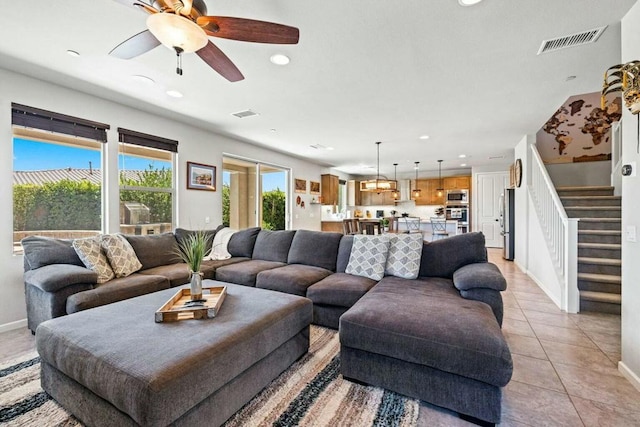 living room featuring light tile patterned flooring and ceiling fan