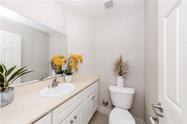 bathroom featuring tile patterned floors, vanity, and toilet