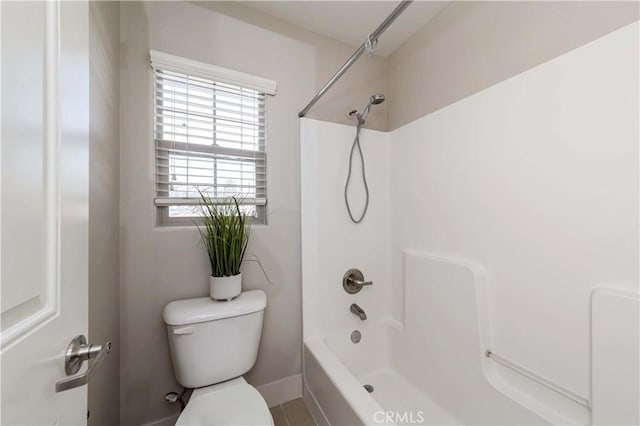 bathroom with bathing tub / shower combination and toilet