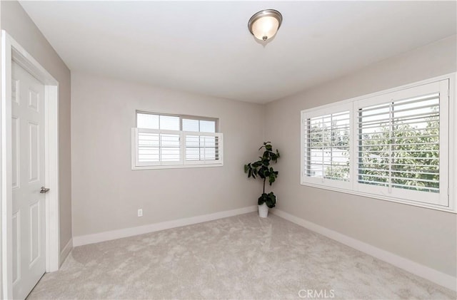 spare room with light colored carpet