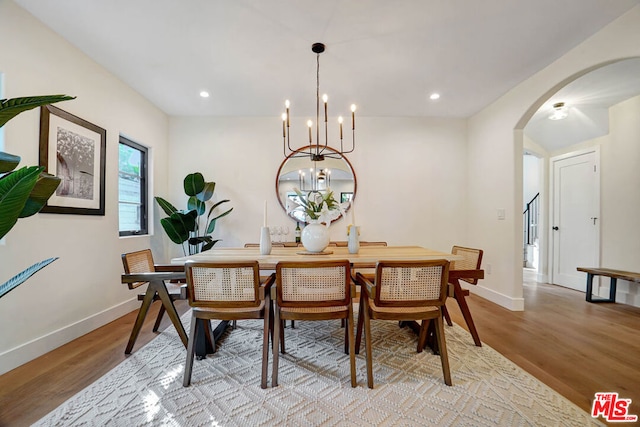 dining room featuring light hardwood / wood-style floors and a notable chandelier