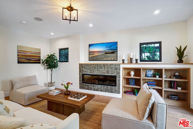 living room with a notable chandelier and light hardwood / wood-style flooring