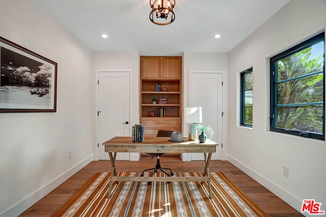 office featuring a chandelier and dark hardwood / wood-style floors