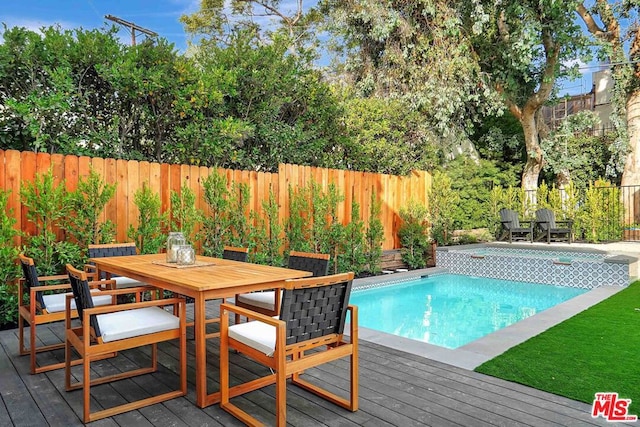 view of swimming pool featuring a deck