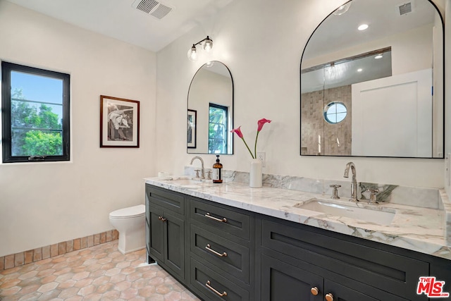 bathroom with tile patterned flooring, vanity, and toilet