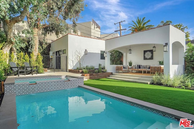 rear view of property featuring a yard, an outdoor living space, and a patio area