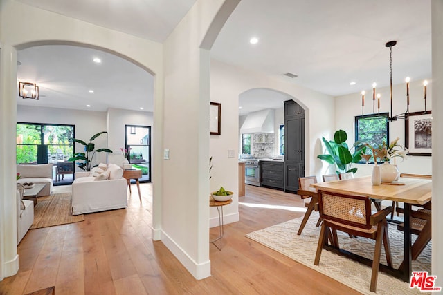 dining area featuring a chandelier and light hardwood / wood-style floors