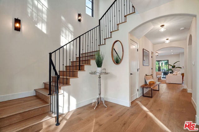 stairs with hardwood / wood-style floors