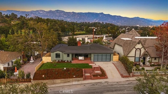 view of front of house featuring a lawn and a mountain view