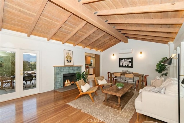 living room featuring vaulted ceiling with beams, wooden ceiling, hardwood / wood-style floors, and a fireplace