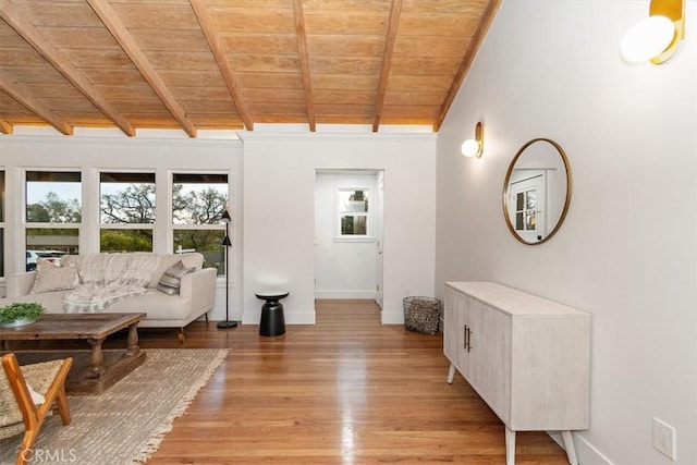 interior space featuring beam ceiling, wooden ceiling, and light hardwood / wood-style flooring