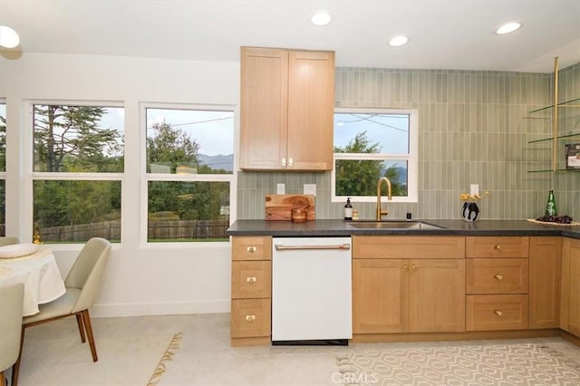 kitchen with decorative backsplash, sink, white dishwasher, and light brown cabinets