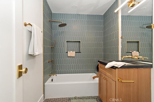 bathroom with tile patterned floors, vanity, and tiled shower / bath combo