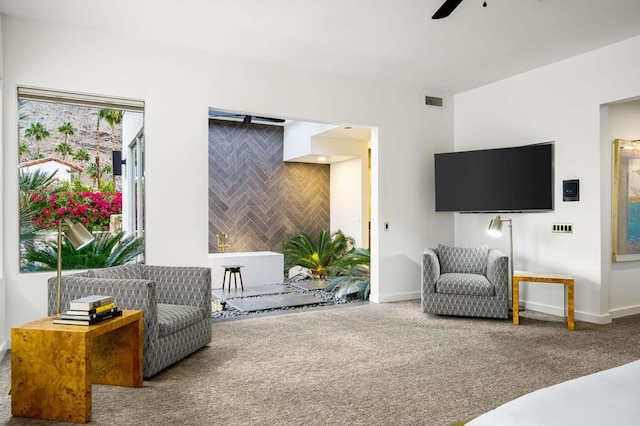 carpeted living room with ceiling fan