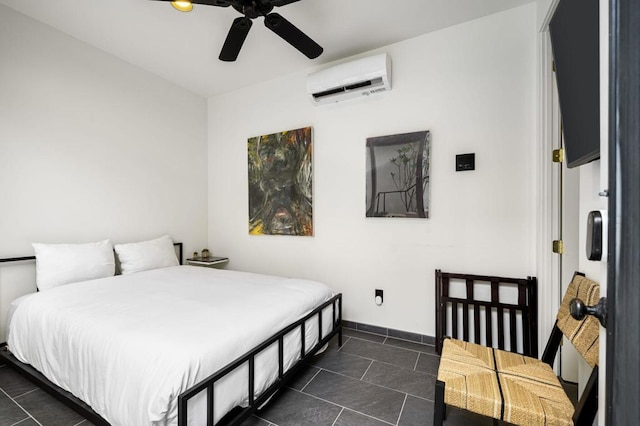 bedroom featuring an AC wall unit, dark tile patterned flooring, and ceiling fan