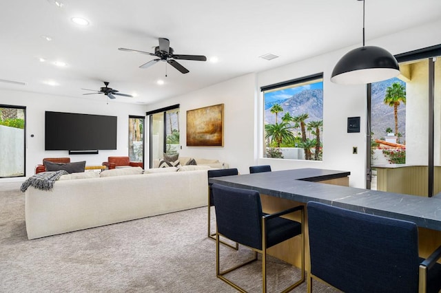 carpeted dining space featuring ceiling fan