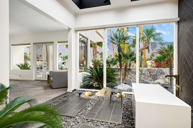 unfurnished sunroom with french doors