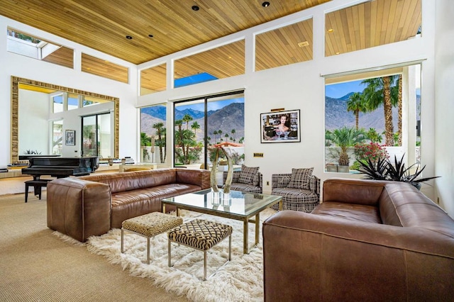 carpeted living room with wood ceiling and a towering ceiling