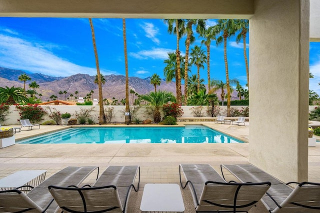 view of pool featuring a mountain view and a patio area