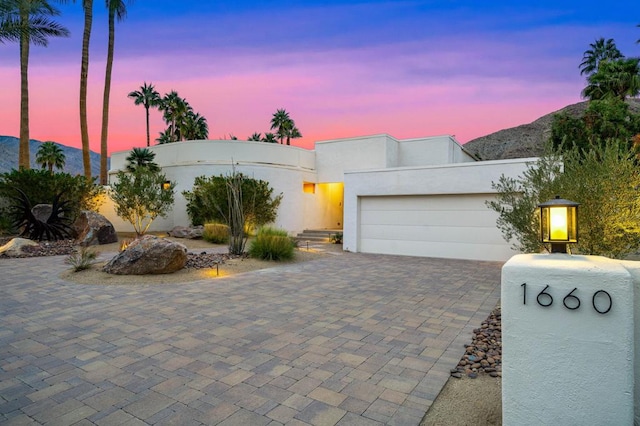 view of front facade featuring a garage and a mountain view