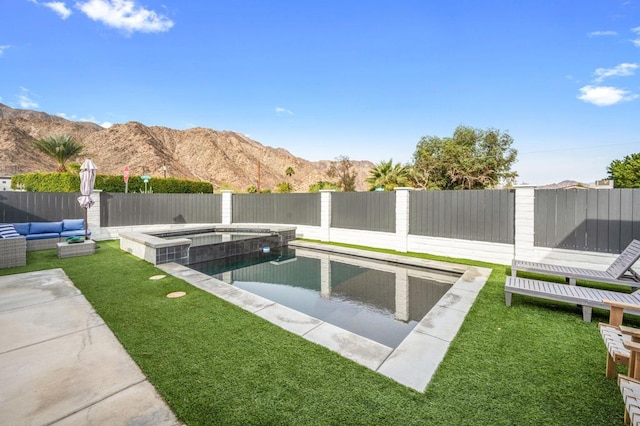 view of swimming pool with an outdoor hangout area, a mountain view, an in ground hot tub, and a lawn