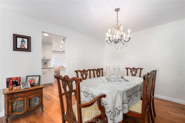 dining area featuring a chandelier and light hardwood / wood-style flooring