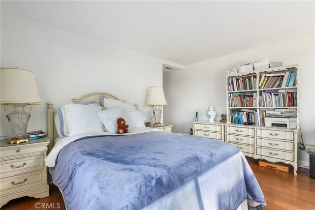 bedroom featuring dark hardwood / wood-style flooring