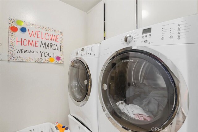 clothes washing area with separate washer and dryer