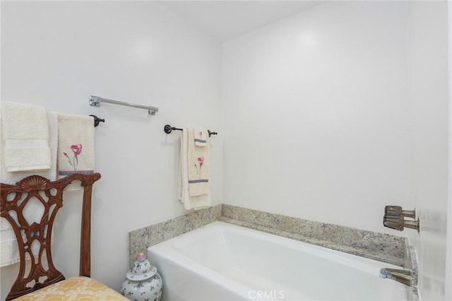 bathroom with a tub to relax in