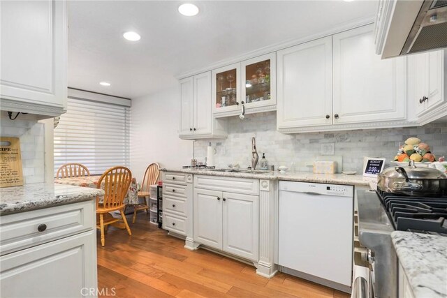 kitchen featuring sink, light hardwood / wood-style flooring, dishwasher, decorative backsplash, and white cabinets