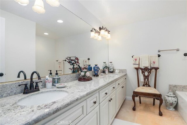 bathroom featuring vanity, tile patterned floors, and a bathtub