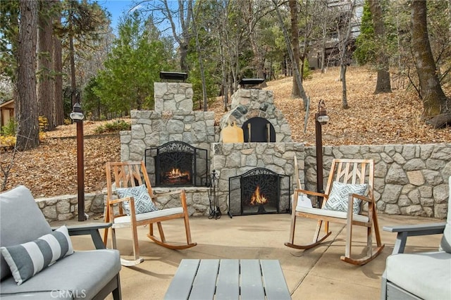 view of patio / terrace with an outdoor stone fireplace