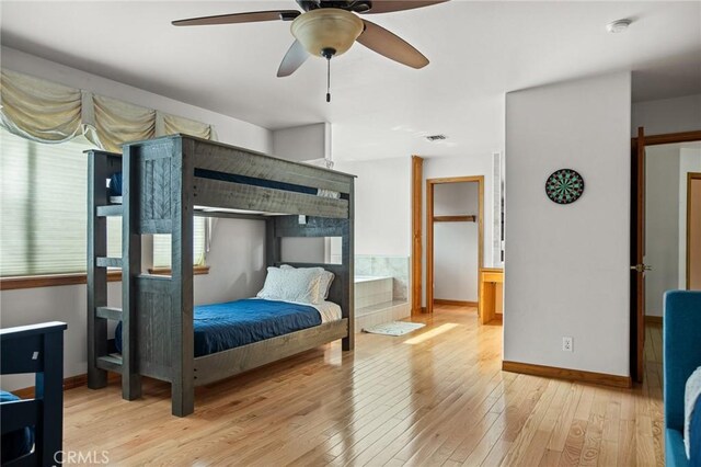 bedroom with light hardwood / wood-style floors and ceiling fan