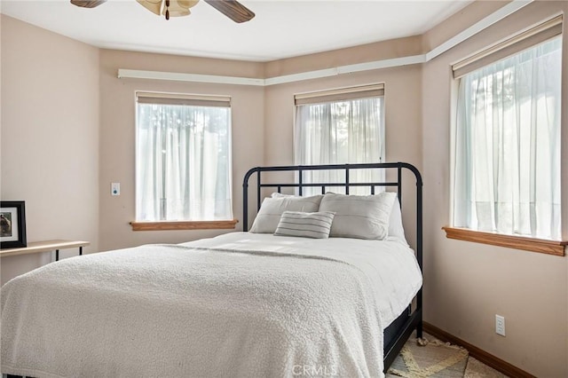 bedroom with multiple windows and ceiling fan